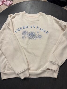 American Eagle Outfitters Cream Crewneck with Light Blue Floral Logo